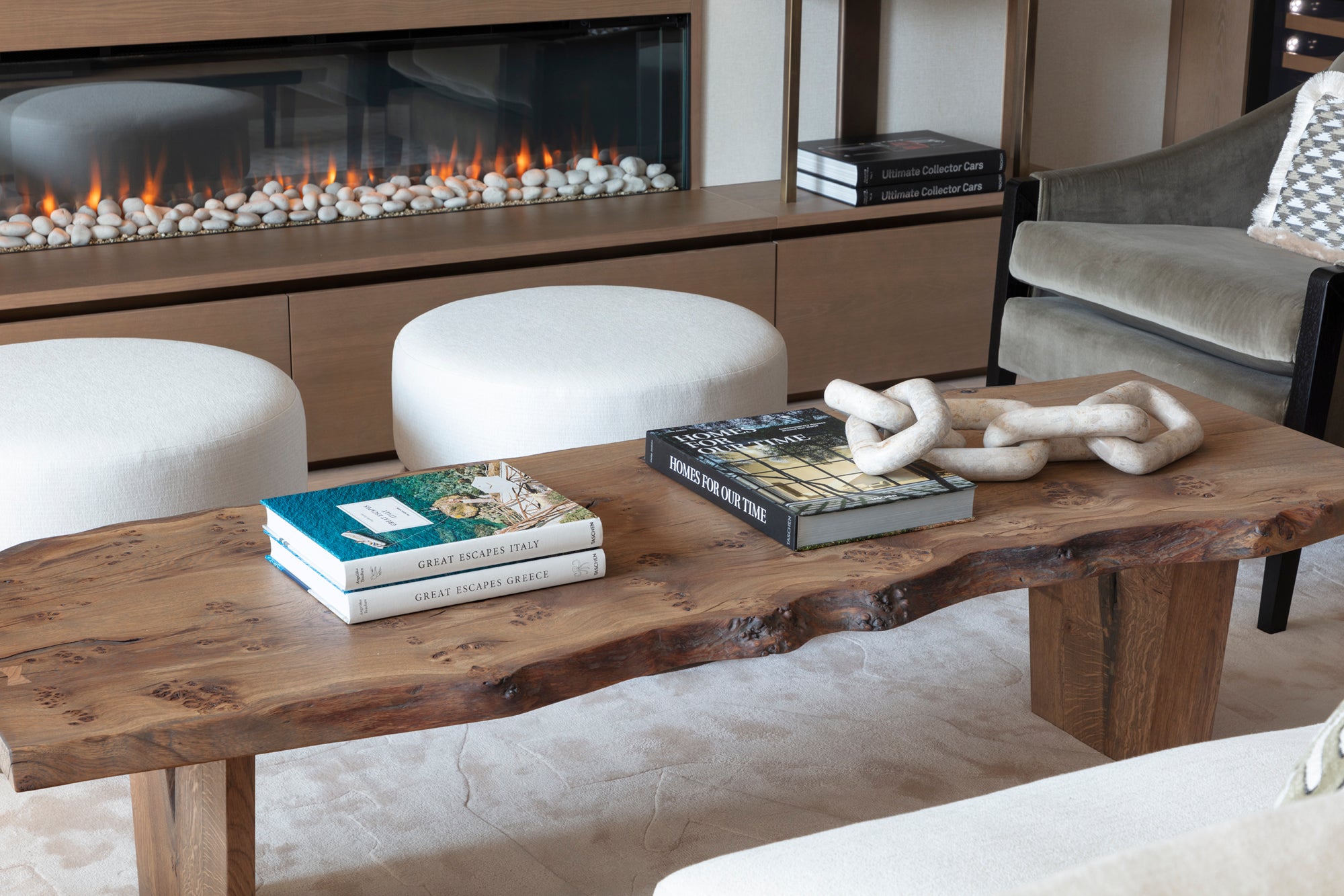 Luxury living space with a natural driftwood coffee table, bespoke furniture and fireplace.