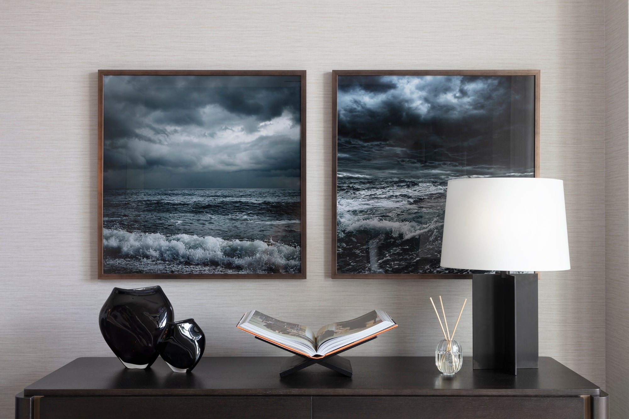 Stormy seas framed artwork with metal lamp, handblown glass vases, book display and luxury diffuser. Styled by Nineteen Interiors.