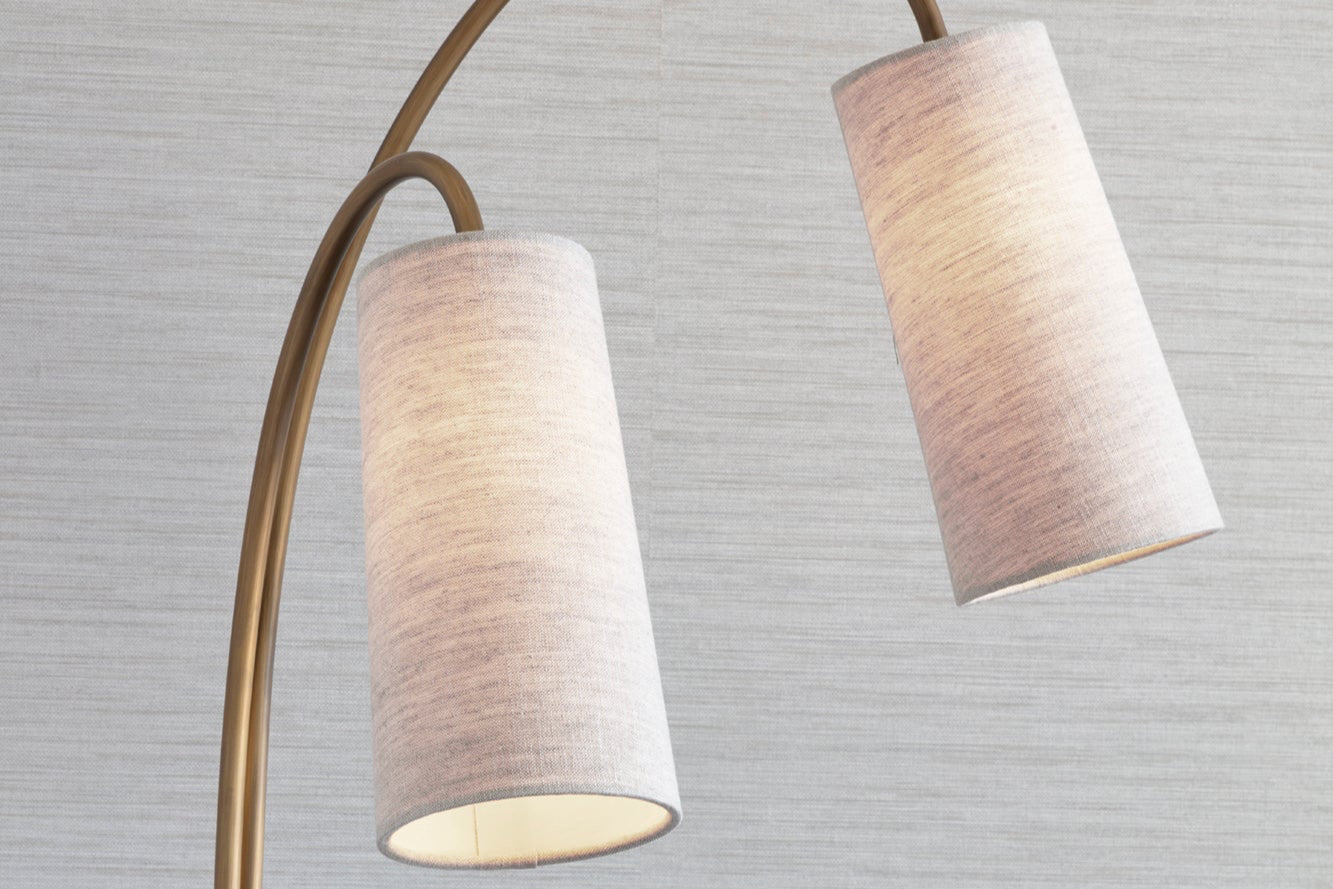 Bespoke made floor lamp with brass detailing and textured wallpaper to luxury Kensington apartment by Nineteen Interiors