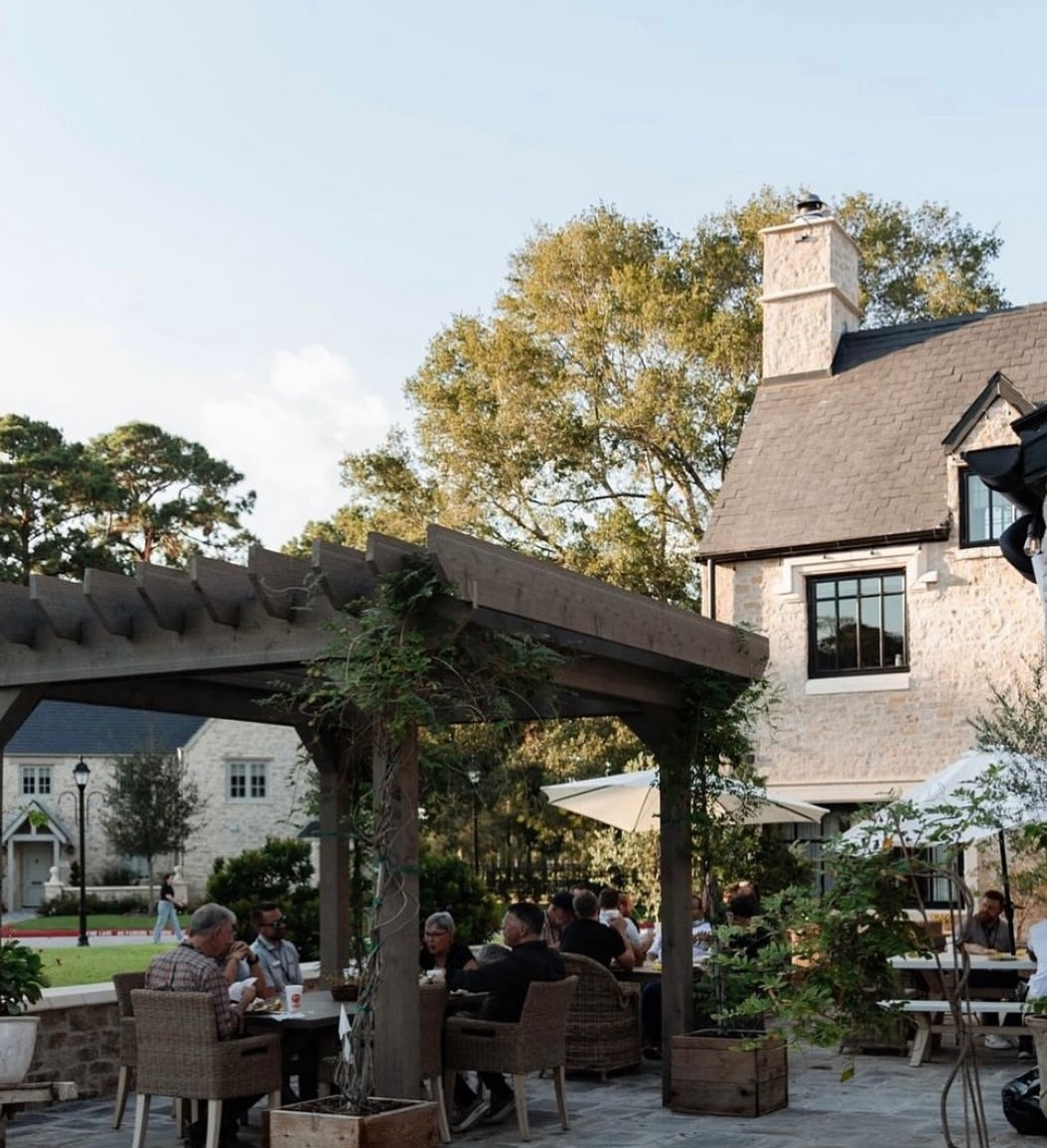 Outdoor setting behind Cotswold inspired pub with greenery all by Nineteen Interiors
