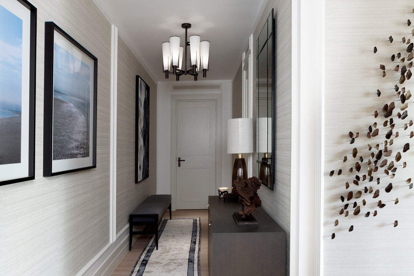 Modern hallway with bespoke framed artwork, feature pendant lighting, handmade joinery and panelling.