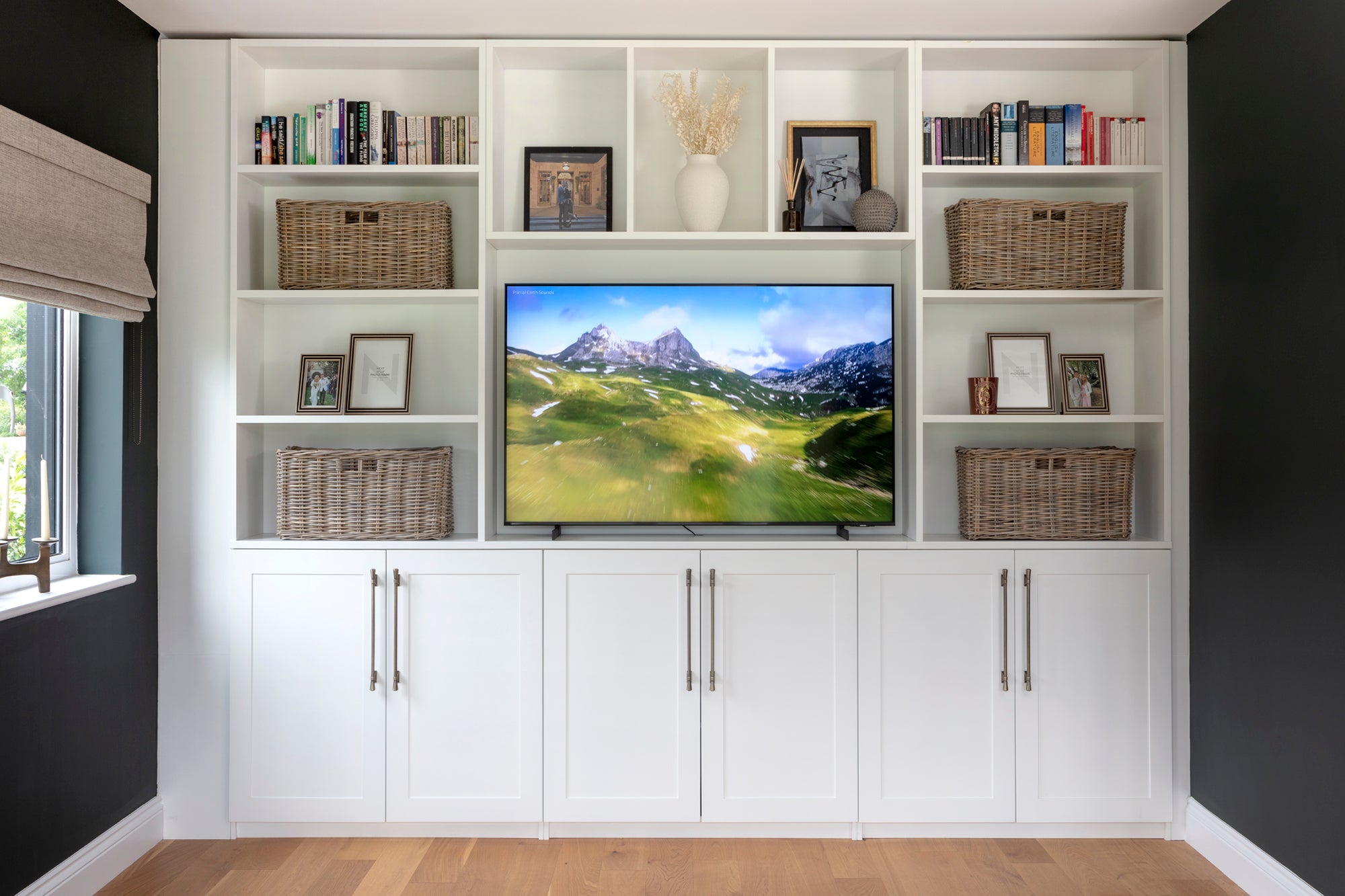 Bespoke wall-to-wall joinery cabinet with personalised accessories and custom blinds in a high-end interior design. The elegant cabinetry is complemented by tailored decor, creating a luxurious and functional space with attention to detail and craftsmanship