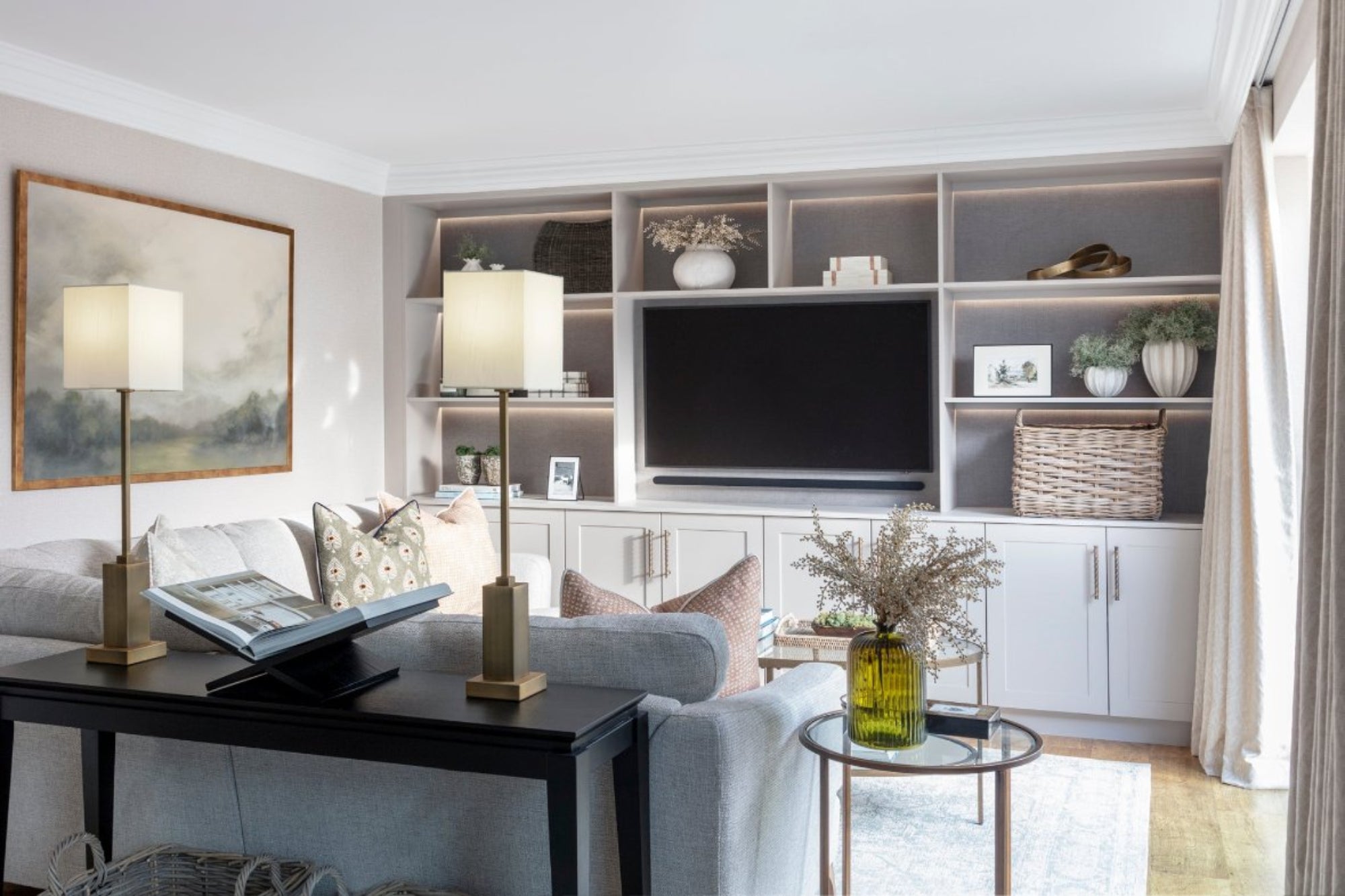 High-end modern contemporary lounge featuring bespoke joinery, a stylish sofa, and a sophisticated rug. The design highlights elegant furnishings and craftsmanship, creating a refined and comfortable living space