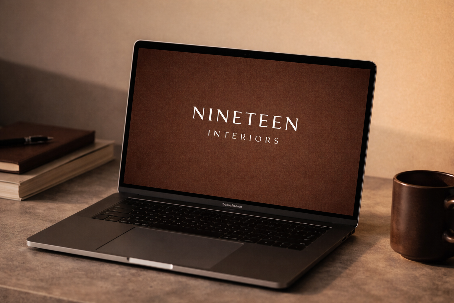 Laptop displaying the Nineteen Interiors logo, representing SEO and digital strategy for a modern interior design studio.